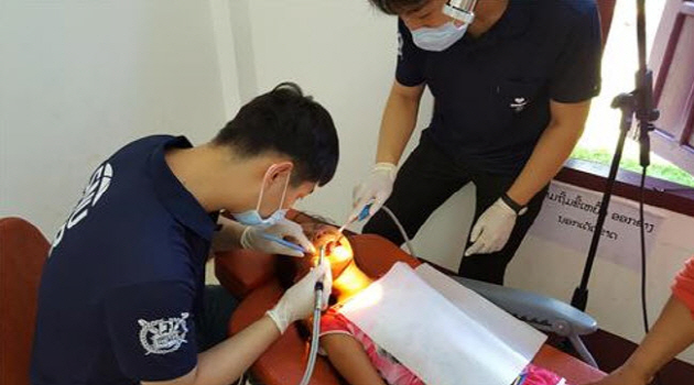 SNU dentists are treating a kid in Laos