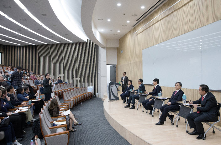 A participant is asking questions to presidential candidates.